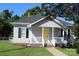 Charming single Gathering home with a freshly manicured lawn and a welcoming yellow front door at 201 Park Ave, Mount Holly, NC 28120