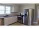 Updated kitchen with stainless steel appliances, granite counters, and subway tile backsplash at 201 Park Ave, Mount Holly, NC 28120