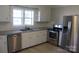 Modern kitchen featuring stainless steel appliances, granite countertops and bright lighting at 201 Park Ave, Mount Holly, NC 28120