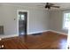 Spacious living room with hardwood floors, ceiling fan, and freshly painted walls at 201 Park Ave, Mount Holly, NC 28120