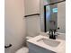 Modern bathroom with stylish sink, speckled counter, and a black trimmed mirror at 2051 Highwood Rd, Rock Hill, SC 29732