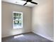 Sunlit bedroom with a ceiling fan and large window offering a street view at 2051 Highwood Rd, Rock Hill, SC 29732