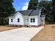 Charming newly built home featuring white siding, dark roof, and a spacious concrete driveway at 2051 Highwood Rd, Rock Hill, SC 29732