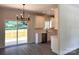 Kitchen boasts white cabinets, stainless steel appliances, and a sliding glass door leading to the deck at 2051 Highwood Rd, Rock Hill, SC 29732