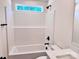Bright bathroom featuring a shower and tub combination with white tile and modern black fixtures at 2063 Highwood Rd, Rock Hill, SC 29732