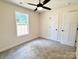 Bright bedroom featuring a ceiling fan, neutral walls, plush carpeting, and natural light from the window at 2063 Highwood Rd, Rock Hill, SC 29732