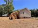 View of the home's exterior featuring a wood deck with stairs and low maintenance yard at 2063 Highwood Rd, Rock Hill, SC 29732