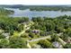Aerial view of a neighborhood with houses, lush trees, and a glimpse of a lake in the background at 2074 Brandt Rd, York, SC 29745