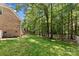 A spacious backyard with lush lawn, mature trees, and a white picket fence at 2074 Brandt Rd, York, SC 29745