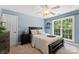 A cozy bedroom with a ceiling fan and large window with outdoor view at 2074 Brandt Rd, York, SC 29745