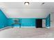 This bonus room has bright blue walls, a TV, and dark furniture at 2074 Brandt Rd, York, SC 29745
