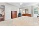 Well-lit bedroom with soft carpet, dressers, and a view of the hallway at 210 Oak Village Pkwy, Mooresville, NC 28117