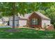 Exterior shows manicured lawn with mature tree providing shade to the house at 210 Oak Village Pkwy, Mooresville, NC 28117