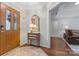 Foyer featuring hardwood floors, a decorative mirror and table, and a view into the adjacent living area at 210 Oak Village Pkwy, Mooresville, NC 28117