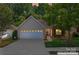 Charming home with a two-car garage, brick facade, manicured lawn, and inviting curb appeal at 210 Oak Village Pkwy, Mooresville, NC 28117
