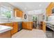 Well-lit kitchen with wood cabinets and a view into the dining area at 210 Oak Village Pkwy, Mooresville, NC 28117