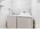 Clean and organized laundry room with ample shelving and white appliances at 210 Oak Village Pkwy, Mooresville, NC 28117