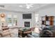 Bright living room with a fireplace, french doors to the back patio, and a comfortable seating area at 210 Oak Village Pkwy, Mooresville, NC 28117