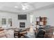 Comfortable living room featuring a fireplace, doors to the backyard, and open access to other rooms at 210 Oak Village Pkwy, Mooresville, NC 28117