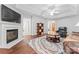 Bright living room with a fireplace, TV, stylish rug, hardwood floors and comfortable seating at 210 Oak Village Pkwy, Mooresville, NC 28117