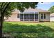 Rear view of the sunroom with brick base and large screened windows at 210 Oak Village Pkwy, Mooresville, NC 28117