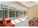 Bright sunroom with lots of windows, light-colored walls, and comfortable furniture at 210 Oak Village Pkwy, Mooresville, NC 28117