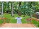 Expansive backyard featuring a fire pit, with a walkway, and well-maintained lawn at 2120 Shadyview Dr, Charlotte, NC 28210
