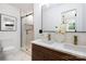 Modern bathroom with double vanity, elegant lighting, and glass-enclosed shower at 2120 Shadyview Dr, Charlotte, NC 28210