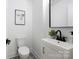 Well-lit powder room featuring black fixtures and patterned tile flooring at 2120 Shadyview Dr, Charlotte, NC 28210
