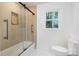 Bathroom featuring a shower over tub and a large window providing natural light at 2120 Shadyview Dr, Charlotte, NC 28210