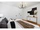 Stylish bedroom with hardwood floors, modern chandelier, and art on the walls at 2120 Shadyview Dr, Charlotte, NC 28210