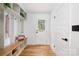 Inviting entryway with built-in bench, hooks, and a view of the front door at 2120 Shadyview Dr, Charlotte, NC 28210