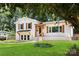 Inviting home with white brick, lush green lawn and mature trees at 2120 Shadyview Dr, Charlotte, NC 28210