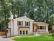 Charming home featuring white brick, wood accents, mature trees, and a well-kept lawn at 2120 Shadyview Dr, Charlotte, NC 28210