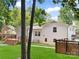 Rear exterior view of the house highlighting the deck, yard, and brick facade at 2120 Shadyview Dr, Charlotte, NC 28210
