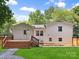 Back exterior showcasing a deck, yard, and access door to the house at 2120 Shadyview Dr, Charlotte, NC 28210