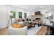 Cozy living room with a brick fireplace, comfortable seating, and ample natural light at 2120 Shadyview Dr, Charlotte, NC 28210