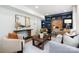 Cozy living room with custom blue built-ins and desk area and light wood flooring at 2120 Shadyview Dr, Charlotte, NC 28210