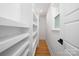 Bright walk-in closet with shelves, hardwood floors, and a window for natural light at 2120 Shadyview Dr, Charlotte, NC 28210