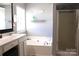 Bright bathroom featuring a soaking tub and a glass enclosed shower at 3092 S Legacy Park Blvd, Fort Mill, SC 29707