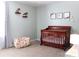 Charming Bedroom featuring a wood crib, unique floral decorations, and a comfortable beanbag chair at 3092 S Legacy Park Blvd, Fort Mill, SC 29707