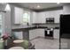 Modern kitchen with white cabinets, stainless steel appliances, and granite countertops at 3092 S Legacy Park Blvd, Fort Mill, SC 29707