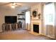 Comfortable living room with a fireplace, large windows, and stylish decor at 3092 S Legacy Park Blvd, Fort Mill, SC 29707