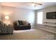 Cozy living room with comfortable seating, a ceiling fan, and a mounted television at 3092 S Legacy Park Blvd, Fort Mill, SC 29707
