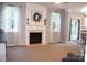 Cozy living room with a fireplace, large windows, and seamless access to the outdoors at 3092 S Legacy Park Blvd, Fort Mill, SC 29707