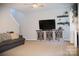 Spacious living room with a decorative fireplace, ceiling fan, and neutral carpet at 3092 S Legacy Park Blvd, Fort Mill, SC 29707