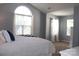 Bright bedroom with an arched window, comfortable bed, and view into an attached sitting area at 3092 S Legacy Park Blvd, Fort Mill, SC 29707