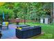 Outdoor patio with comfortable seating, a fire pit, and a beautifully landscaped backyard at 3092 S Legacy Park Blvd, Fort Mill, SC 29707