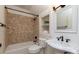 Cozy bathroom features a tub with diamond patterned tile surround, a white sink and a built-in display niche at 3408 Sandalwood Ln, Waxhaw, NC 28173