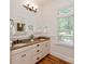 Bathroom featuring double sink vanity with granite countertop, and warm lighting at 3408 Sandalwood Ln, Waxhaw, NC 28173